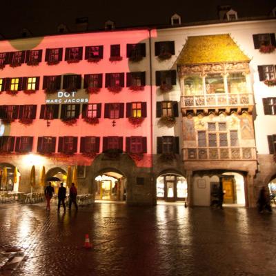 Projektion mit Werbung für Parfum Dots auf Fassade Goldenes Dacherl in der Nacht