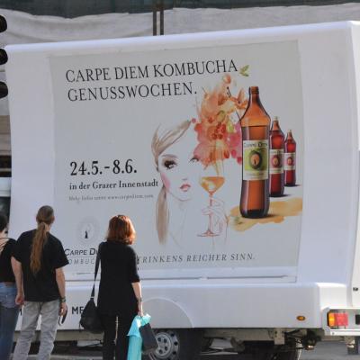 2 mobile Plakate auf Kleinlaster weiss mit Werbung für Carpe Diem in Stadtverkehr