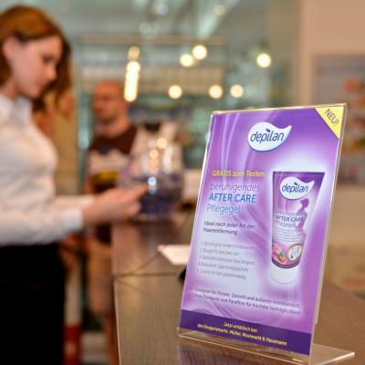 Frau probiert Produktproben beim Check In im Fitness Studio