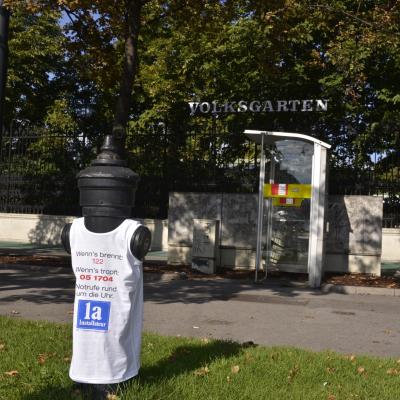 weisses Werbe T-Shirt für Installateure ist über Hydrant gezogen in Innenstadt