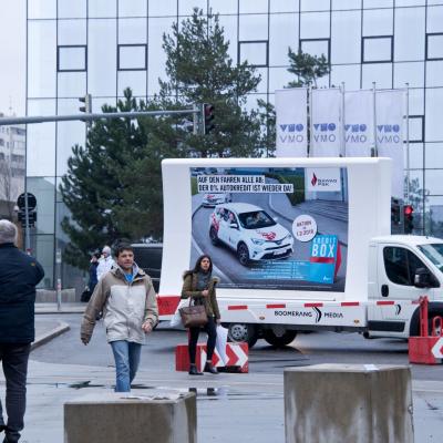 16 Bogen Plakat auf weissem Auto mit Werbung für BAWAG im Großstadtverkehr